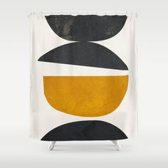 an abstract shower curtain with black, yellow and white shapes on the outside of it