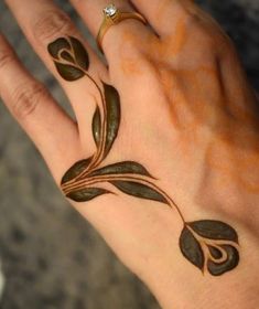 a woman's hand with some tattoos on it