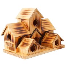 three wooden bird houses sitting on top of each other