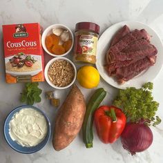 the ingredients are laid out on the counter to be used in this meal, including meat and vegetables