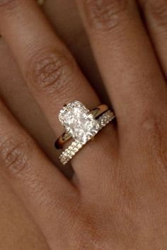 a woman's hand with a diamond ring on it