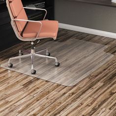 an office chair sitting on top of a hard wood floor next to a computer desk