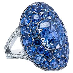 Alex Jona design collection, hand crafted in Italy, 18k white gold solitaire ring, centering a certified natural unheated 8.04 carats cushion cut Ceylon blue sapphire, surrounded by 7.32 carats of blue sapphires. The shoulders are set with 0.97 carats of white diamonds, F color, VVS1 clarity. Ring size: 6.0 US/12 EU Dimensions: W 0.74in/19mm x L 1.0in/25.50mm Alex Jona jewels stand out, not only for their special design and for the excellent quality of the gemstones, but also for the careful att Elegant Pouch, High Jewelry Ring, White Gold Solitaire, Gold Solitaire Ring, Contemporary Ring, White Gold Ring, Design Collection, White Diamonds, Special Design