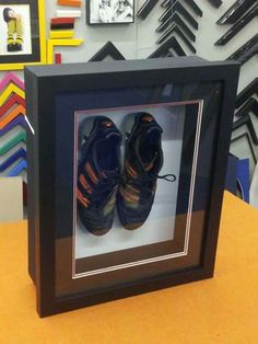 a pair of shoes is in a shadow box