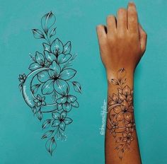 a person's hand with a tattoo on it next to a drawing of flowers