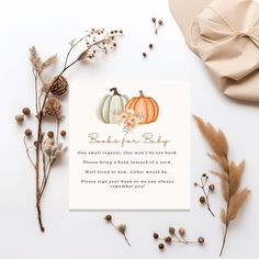 a card with two pumpkins on it next to some dried flowers