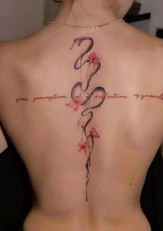 the back of a woman's neck with a tattoo on it