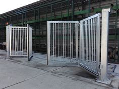 two metal gates are open in front of a building