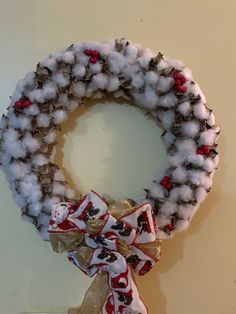 a wreath made out of cotton and ribbon