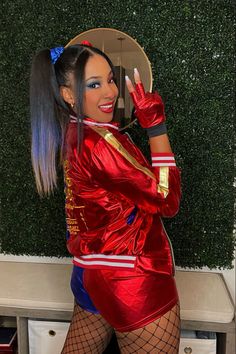 a woman dressed in red and blue posing for the camera