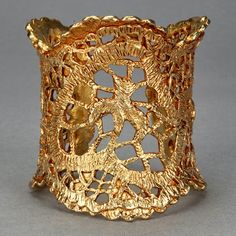 Features: - 100% Authentic CHRISTIAN LACROIX. - Gilt textured wide cuff in gold tone. - Detailed Christian Lacroix emblems in openwork lace pattern. - Signed Christian Lacroix CL Made in France. - Excellent vintage condition. Measurements: Height: 2.75 inches (7.7 cm) Inner Circumference: 6.69 inches (17.5 cm) includes opening **This cuff bracelet will be shipped via DHL Express Shipping with tracking number. Please convo me for any queries and additional photos. Thank you for visiting. Other Fe Unique Gold Cuff Bracelet With Intricate Design, Gold Cuff Bracelet With Intricate Design, Unique Gold Wide Band Cuff Bracelet, Gold Filigree Cuff Bracelet As Gift, Christian Lacroix Jewelry, Wax Carving Jewelry, Lace Cuff Bracelet, Lace Cuffs, Jeweled Earrings