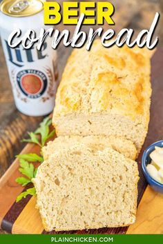 a loaf of beer bread on a cutting board next to a can of beer