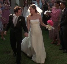 a bride and groom walking down the aisle