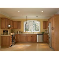 a large kitchen with wooden cabinets and stainless steel appliance in the center area