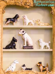 there are many dog figurines on the shelves