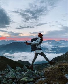 a man hiking up the side of a mountain with his back pack on top of it