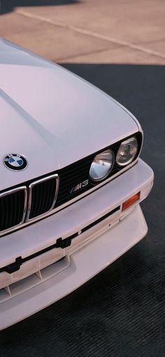 the front end of a white bmw sports car