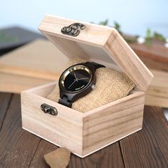 a wooden box with a watch in it