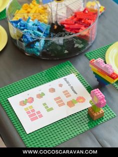 the table is set up with legos and paper plates