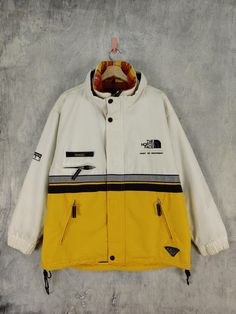 Used Item 100 Cotton Made in China Size X Large Great Condition  Tag TNF Measurements  Chest 22.5 Inch Length 30.5 Inch Vintage Yellow Windbreaker For Winter, White 90s Windbreaker For Fall, 90s Style White Windbreaker For Fall, Vintage White Hooded Outerwear, Vintage White Outerwear For Streetwear, 90s White Winter Outerwear, 90s Style White Winter Outerwear, Vintage White Windbreaker For Fall, White Hooded 90s Outerwear