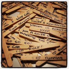 a pile of wooden signs with writing on them