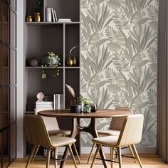 a dining room table with two chairs and a bookcase behind it, in front of a wallpapered design