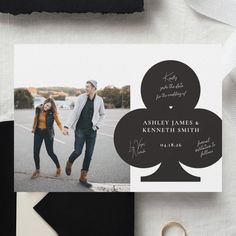 an image of a couple holding hands in front of a black and white wedding card