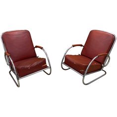 a pair of red leather chairs with chrome frame and footrests on white background