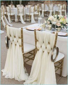 the chairs are covered with white cloths