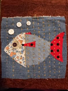 a patchwork piece with buttons and fabric on it