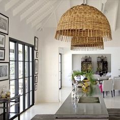 an open kitchen and dining room with wicker chandelier