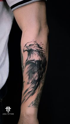 a man's arm with an eagle tattoo on it