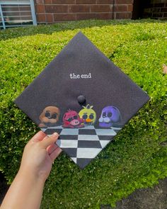 someone is holding up a graduation cap that says the end