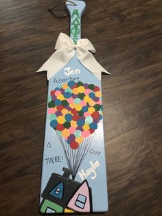 a bookmark shaped like a house with balloons on it