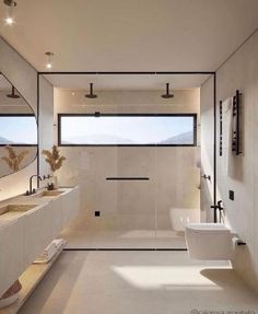 a modern bathroom with two sinks and mirrors