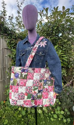 a woman's handbag is displayed on a mannequin head