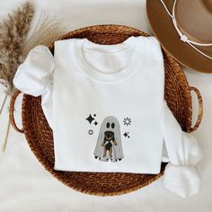 Introducing our adorable Cute Ghost Holding Puppy Embroidered Sweatshirt 2D For Family! This sweatshirt is perfect for those who love cute and spooky designs, and it will surely become a favorite addition to your wardrobe. Our sweatshirt features a beautifully embroidered design of a cute ghost holding a puppy. The intricate details and vibrant colors bring this design to life, making it a truly eye-catching piece. The embroidery is skillfully done, ensuring that it will last for a long time wit White Kawaii Sweatshirt For Fall, Spooky White Cotton Sweatshirt, White Spooky Cotton Sweatshirt, White Cotton Spooky Sweatshirt, Holding Puppy, Cute And Spooky, Spooky Designs, Embroidered Sweatshirt, A Puppy