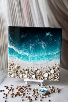 an ocean scene is shown with shells on the table