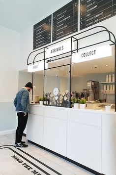 a man standing in front of a counter at an airport