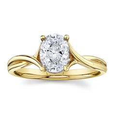 a yellow gold engagement ring with an oval cut diamond in the center and twisted band