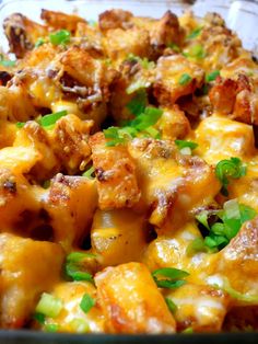 a close up view of a casserole dish with meat, cheese and vegetables