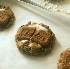 cookies with white frosting and chocolate chips on a baking sheet