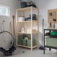 a bicycle is parked in the garage next to shelves with tools and containers on them