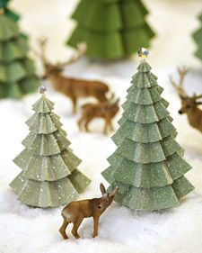 miniature christmas trees and deer in the snow