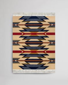 a multicolored rug hanging on a wall