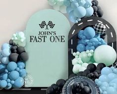 there is a sign that says john's fast one and balloons in front of it