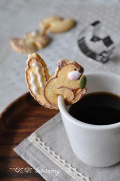 a cup of coffee and some cookies on a table