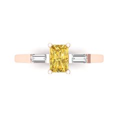 a yellow diamond ring with two baguets on the sides and an accent band