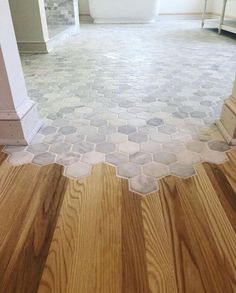 a bathroom with wooden floors and white walls