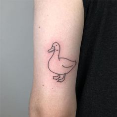 a small duck tattoo on the arm